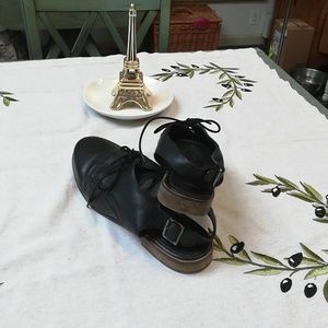 Black brogue type flats